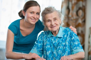 Senior woman with her caregiver at home